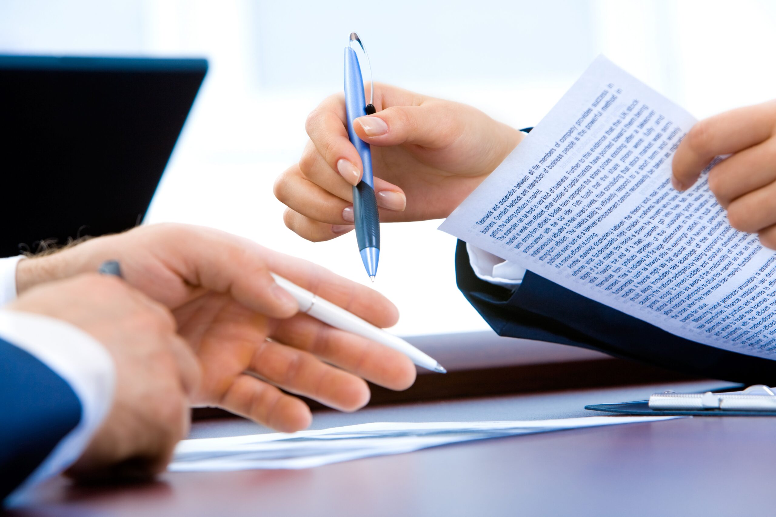 Close-up of professionals reviewing skills of workers