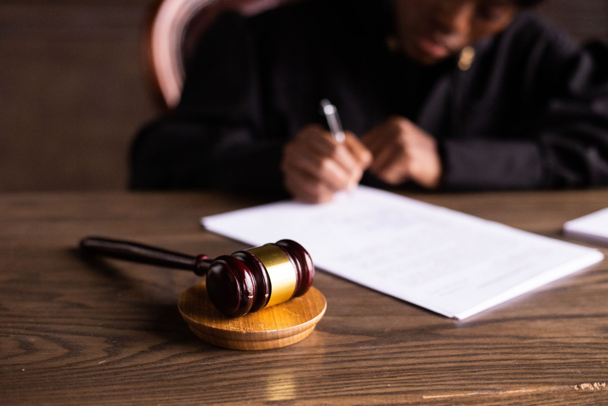Judge signing documents at desk