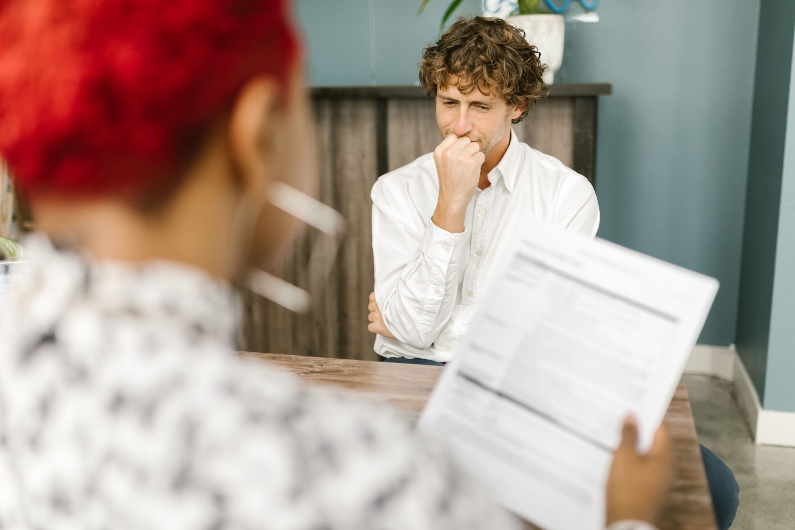Man reflecting during a job interview in an office setting