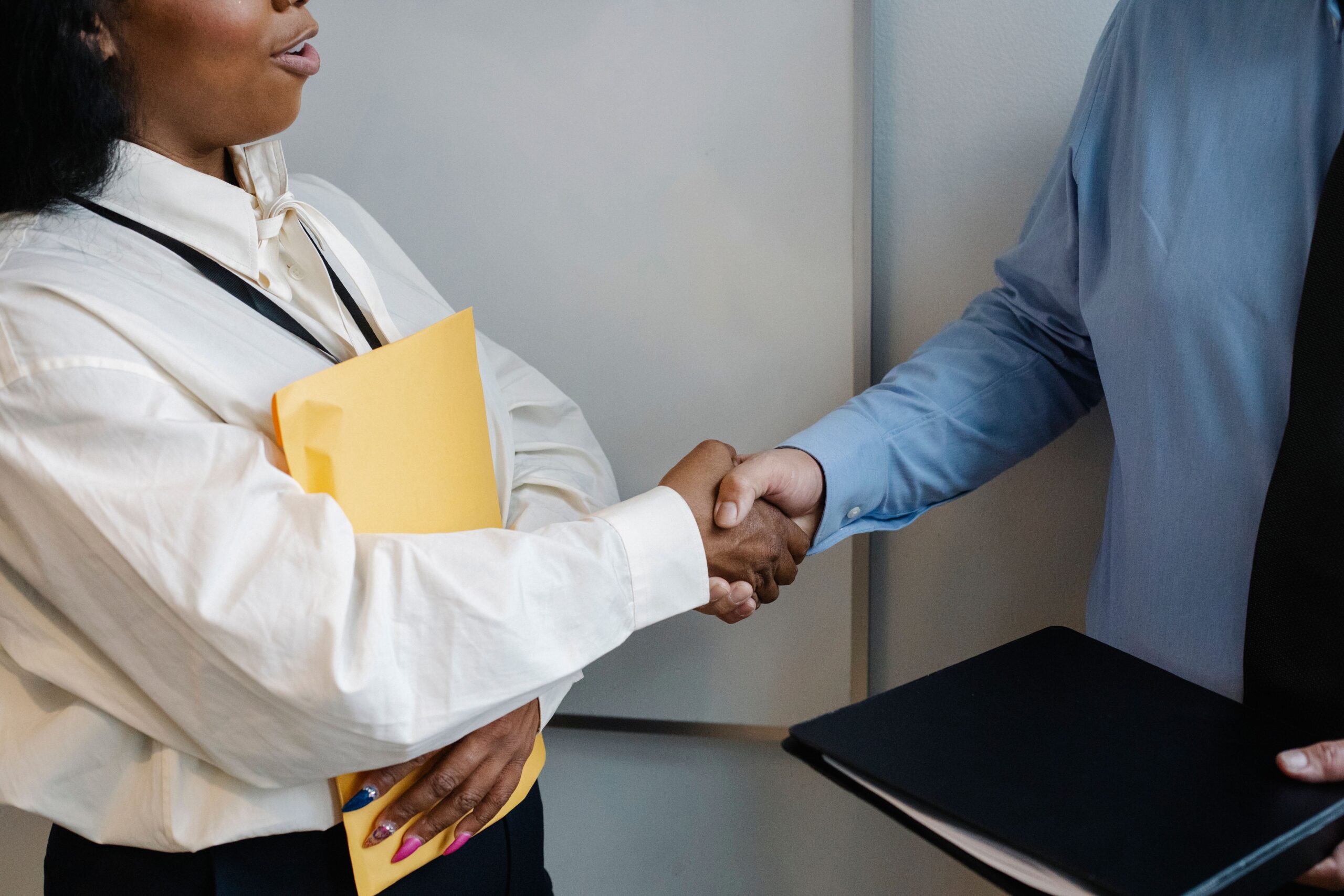 Two professionals shaking hands in an office setting