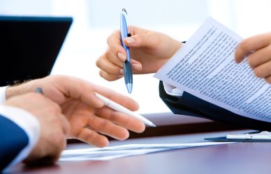 Close-up of professionals reviewing skills of workers