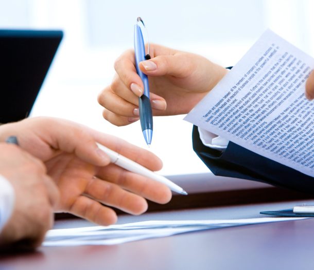 Close-up of professionals reviewing skills of workers