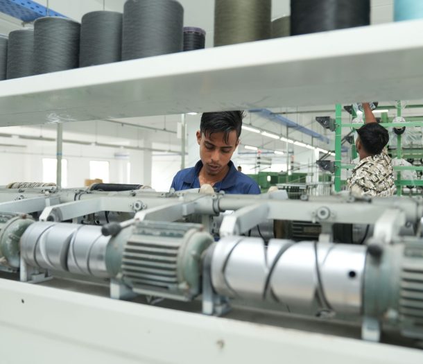 Industrial textile factory interior with workers operating machinery