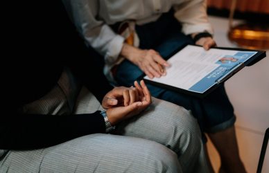Two people checking the Resume