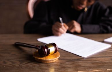 Judge signing documents at desk
