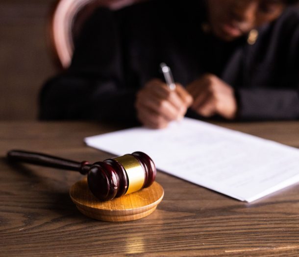 Judge signing documents at desk