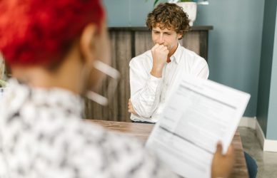 Man reflecting during a job interview in an office setting