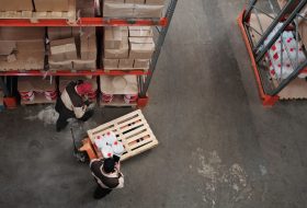 High angle view of workers organizing inventory in a warehouse
