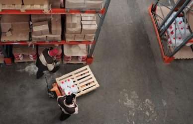 High angle view of workers organizing inventory in a warehouse