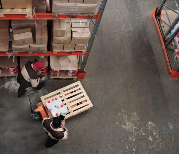 High angle view of workers organizing inventory in a warehouse